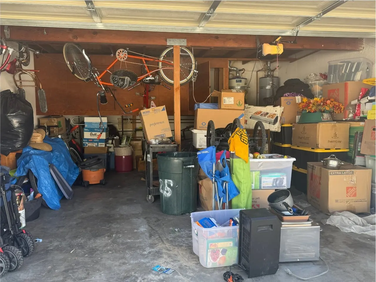 Garage with bicycles, boxes, bins, and other stored household items